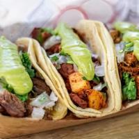 Tacos Acorazados · One large taco double corn tortilla with a layer of rice and meat of your choice. topped wit...