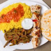 Chicken Shish Kabob · Marinated and seasoned chunks of grilled chicken breast on a skewer with peppers and onions....