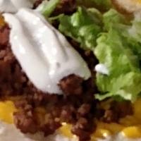 Soft Shell Beef Taco · Grilled cheese tortilla shell with lettuce, tomato, cheese, sour cream and sauce.