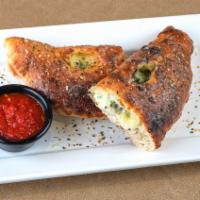 Classic Calzone · Sweet Italian sausage, cheddar, provolone and mozzarella cheeses, pepperoni, ham,
red onions...