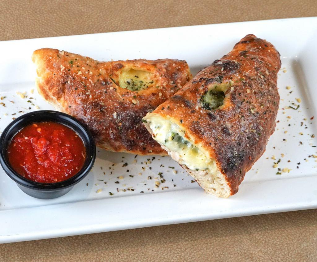 Classic Calzone · Sweet Italian sausage, cheddar, provolone and mozzarella cheeses, pepperoni, ham,
red onions, green peppers, and fresh mushrooms. Served with marinara sauce.