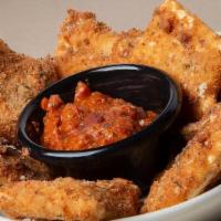 Toasted Ravioli · Our delicious cheese ravioli, lightly hand-breaded and fried golden brown. Served with meat ...