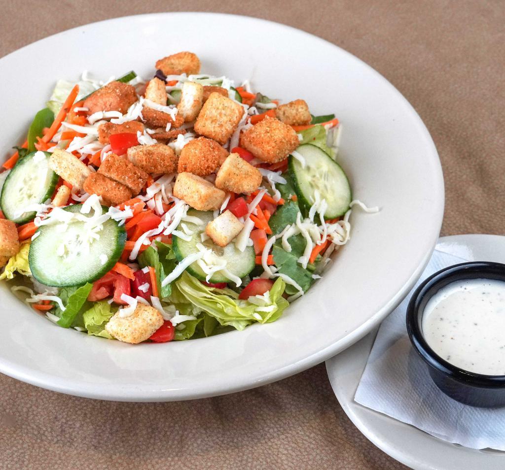 Garden House Salad · Zio’s mixed greens blend, cucumber slices, diced tomato, carrots, shredded mozzarella, and homestyle herb croutons served with your choice of house-made dressing.