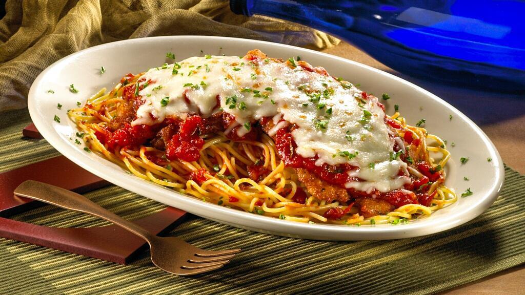 Chicken Parmigiana · Favorite. A lightly breaded chicken breast topped with marinara sauce,
melted mozzarella, and Parmesan cheese. Served on a bed of spaghetti.