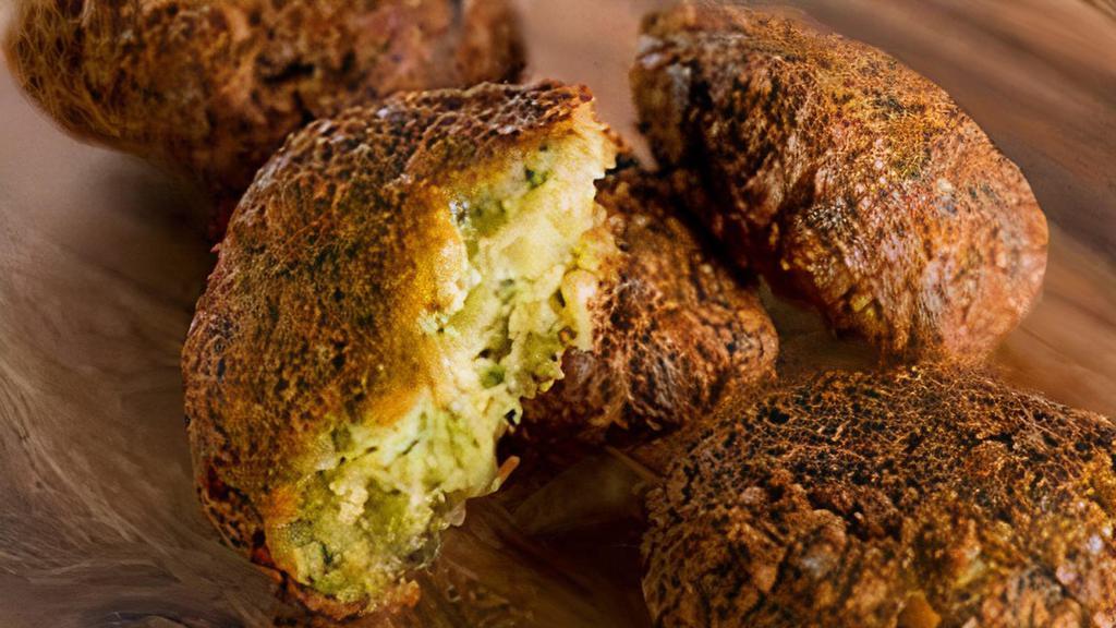 Falafel · Six pieces garbanzo beans with parsley, cilantro, onion, garlic, and spices deep fried, served with cucumber sauce.