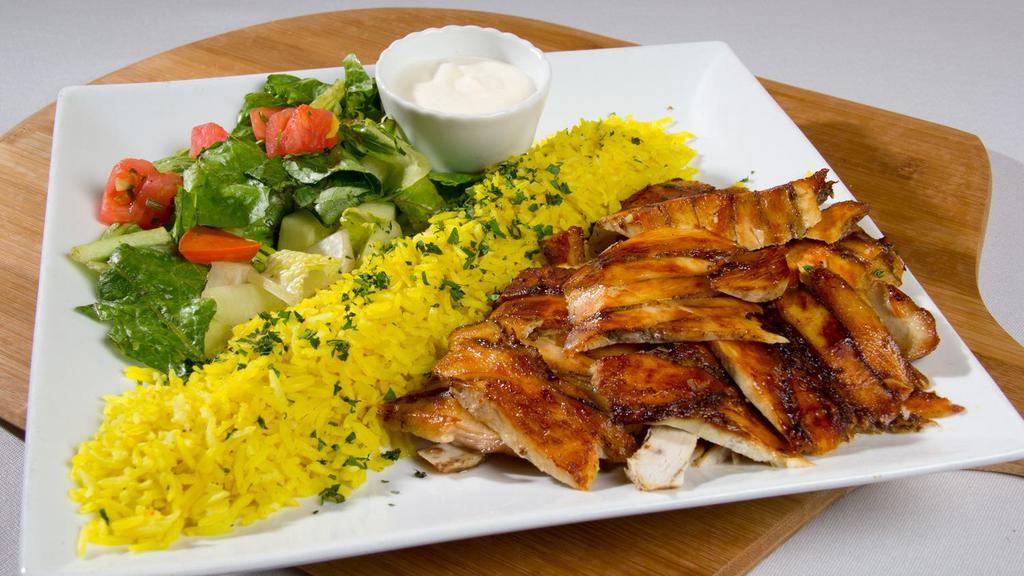 Shawarma Plate · Thin slices of marinated chicken or steak, cooked on a slow revolving rotisserie. Served with rice and house salad.