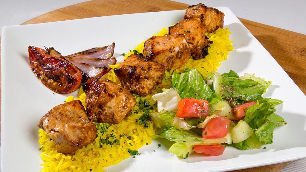 Chicken Kabab (Taouk) · Marinated mediterranean style grilled chicken breast cubes, served with rice and house salad.