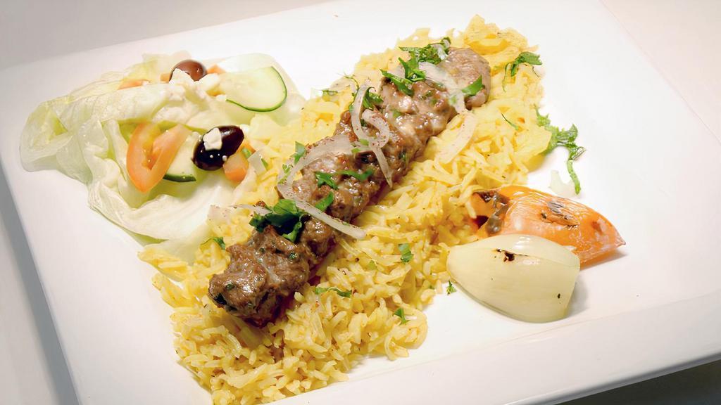 Kufta Kabab · Grilled ground lamb/ beef with minced onion, parsley fresh herbs, served with rice and house salad.
