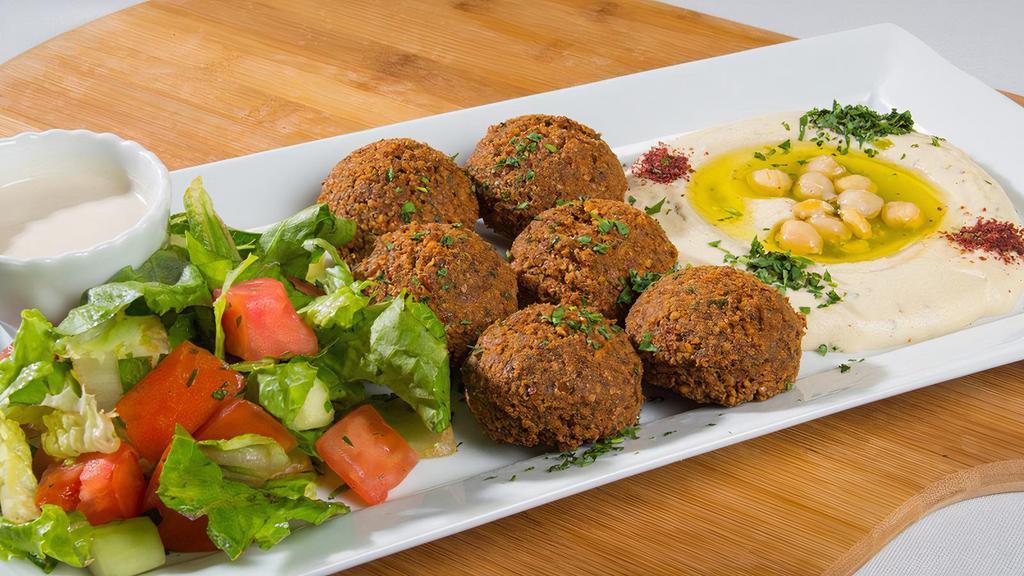 Falafel Plate · Six pieces of falafel, hummus, house salad, served with tahini sauce and pita bread.