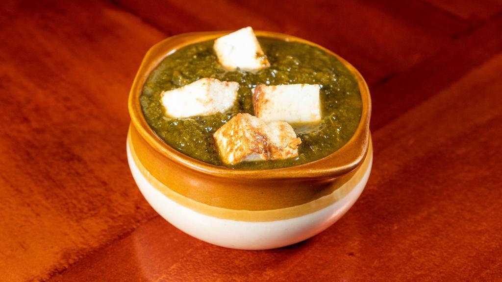 Palak Paneer · A spinach cooked with cubes of Indian cheese and spices.
