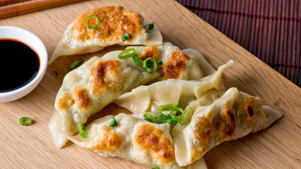 Vegetable Momo · Hand wrapped steamed veggie dumplings made with potato, cabbage, tofu, cilantro, green peas and onions.