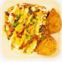 Samosa Chat · Savoury snack made with chick peas, samosas and assorted sauces