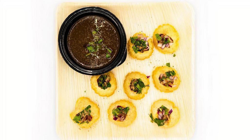 Pani Puri · Hollow, fried, crispy puri filled with a mixture of flavored water, potato, onions and chutneys