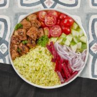 Cheeky Chicken Kebab Bowl · Yellow rice, Jerusalem salad topped with grilled chicken kebobs dressed with tahini sauce.