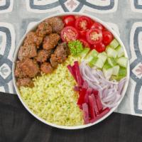 Go Go Gyro Bowl · Gyro meat served with yellow rice and Jerusalem salad.
