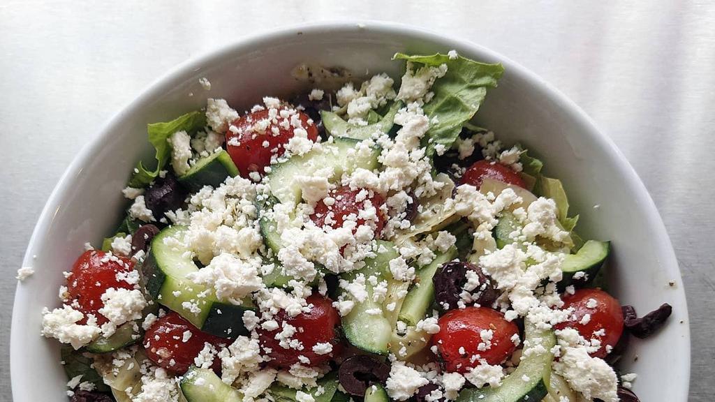 Greek Salad · Romaine, Kalamata olives, marinated artichokes, cucumbers, roasted tomatoes, feta cheese dressed in white balsamic and herb vinaigrette.