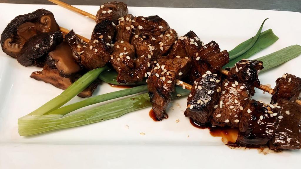 Steak Skewers · 2 sticks worth of Grilled all-natural angus beef, marinated in our house seasonings. Served with grilled scallion and sliced shiitake mushrooms.