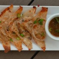 Veggie Gyoza (4) · Wonton wrappers with vegan filling. Grilled to a golden brown and served with soy ginger sau...