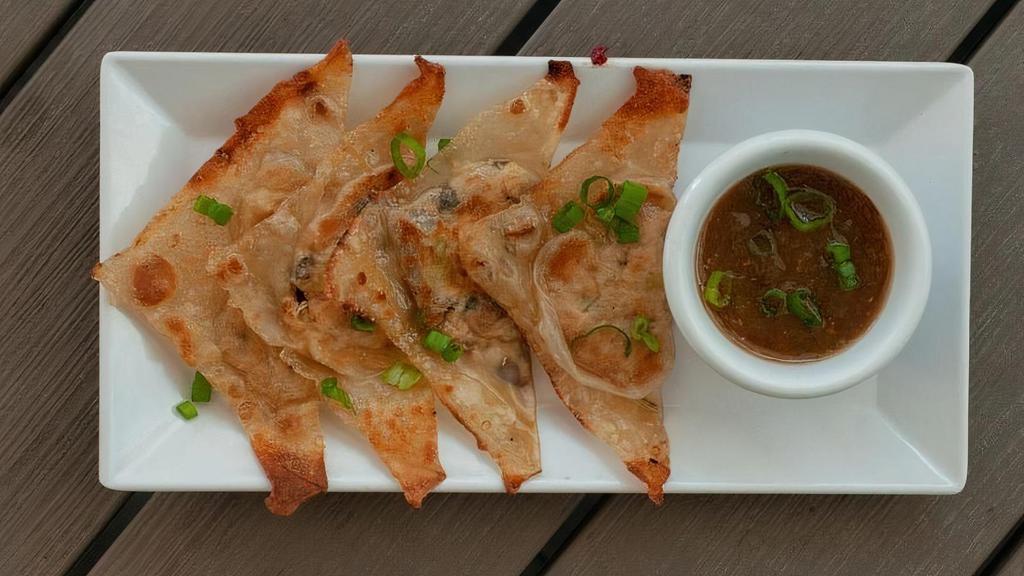 Veggie Gyoza (4) · Wonton wrappers with vegan filling. Grilled to a golden brown and served with soy ginger sauce.
