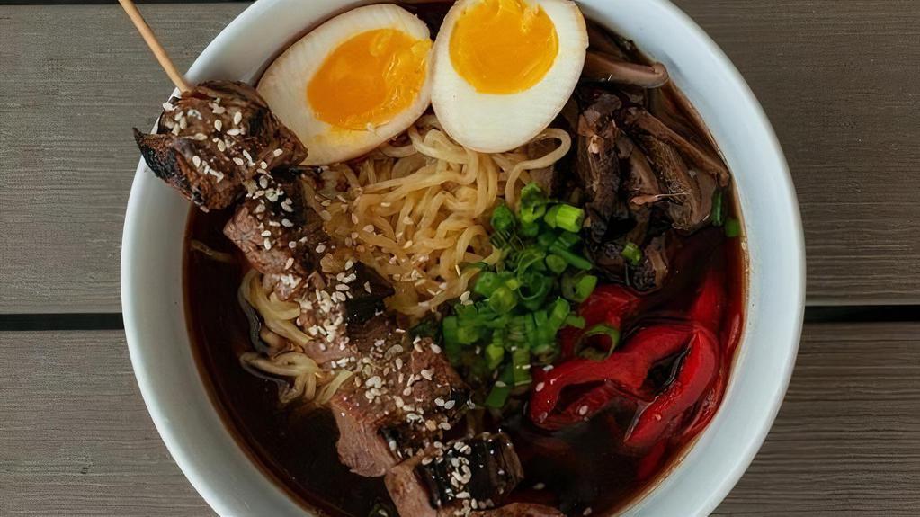Steak Ramen · Ramen noodle soup with Shoyu broth, all-natural angus steak, marinated shiitakes, soft-cooked free-range egg, red bell peppers, scallions, and cilantro.
