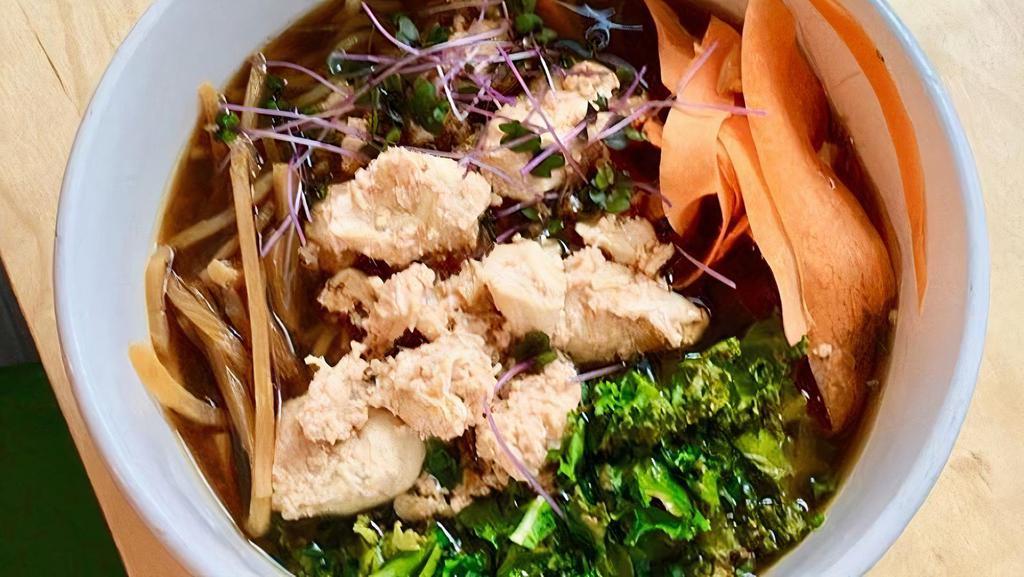 Free-Range Chicken Ramen · Ramen noodle soup with Shoyu broth, free-range chicken, kale, bamboo, ginger carrots, scallions, and cilantro.