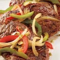 Pepper Steak · Stir-fried flank steak, green peppers, and onions with brown sauce.