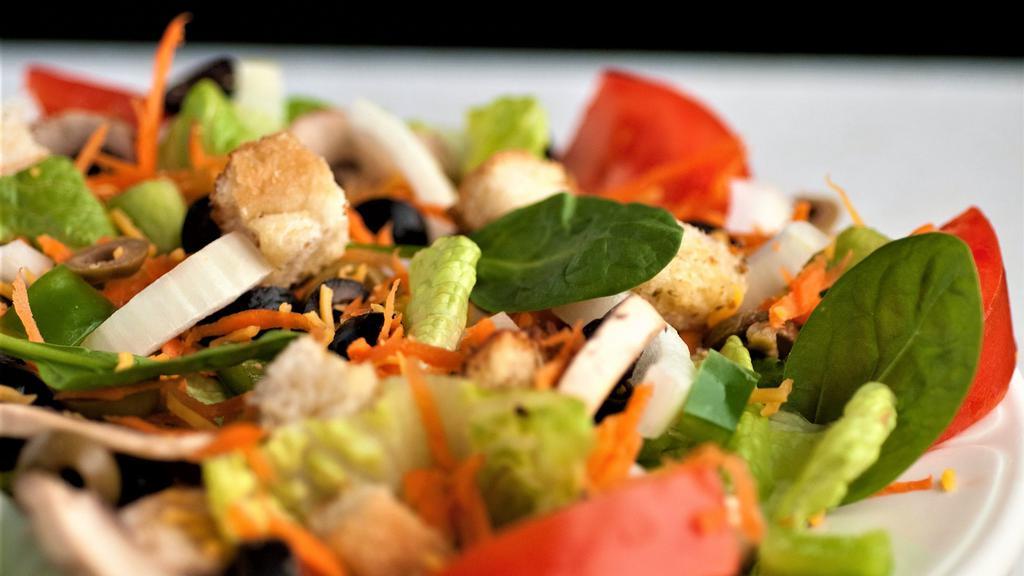 Garden Salad · Mixed lettuce, spinach, tomatoes, onions, green and black olives, mushrooms and green peppers with shredded carrot, Cheddar cheese and homemade croutons.