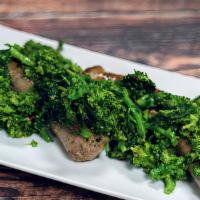 Broccoli Rabe & Sausage · Bitter Italian greens sauteed in garlic & olive oil, served with our Italian sausage.