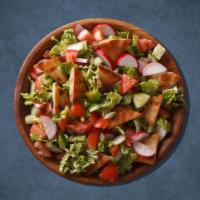 Fattoush Supreme Salad · Romaine lettuce, juicy tomatoes, cucumbers, onions, and tossed with pita chips and sumac dre...
