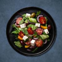 Greek Salad Getaway · Romaine lettuce, topped with tomatoes, onions, cucumber, and our fresh pita chips, and sumac...