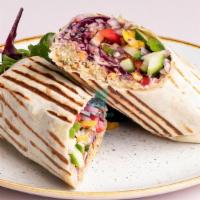 Hummus Falafel Sandwich Wrap · Fresh hummus, falafel, tomatoes, lettuce, and onions are wrapped to perfection.