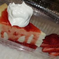 Strawberry Cheesecake · Fresh thick cut cheesecake with strawberries and whipped cream