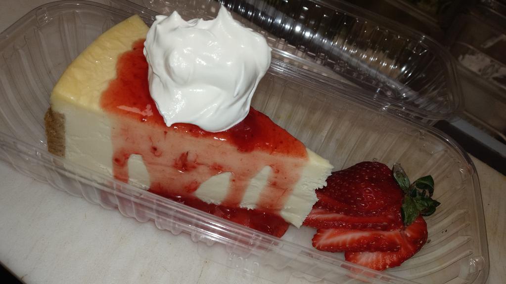 Strawberry Cheesecake · Fresh thick cut cheesecake with strawberries and whipped cream