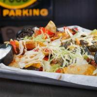 Nachos · House made tortilla chips piled high . with cheese blend, lettuce, corn salsa, . guacamole, ...
