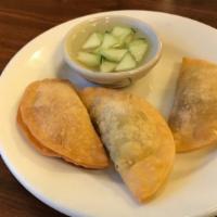 Curry Puff (6) · Deep-fried wonton wraps stuffed with ground chicken, minced onions, diced potatoes, curry po...