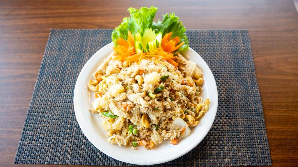 Pineapple Fried Rice · Choice of meat, fried rice with egg, pineapple, cashews, white and green onions, carrots, and peas.