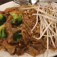 Pad See' Ew · Choice of meat, stir-fried wide rice noodles with egg, broccoli in Thai sweet brown sauce an...