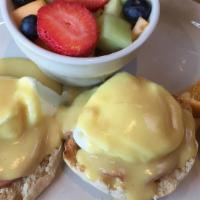 Eggs Benedict Florentine · English muffin, Canadian bacon, spinach, tomato, poached eggs and hollandaise, served with h...