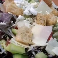 House Side Salad · Vegan. Arcadian and romaine lettuce, diced tomato, cucumber, parmesan, and croutons.