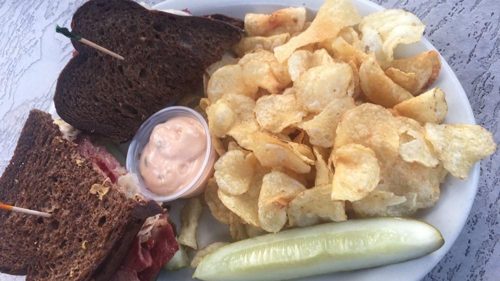 Reuben · Corned beef piled high under melted swiss cheese and sauerkraut, with a side of thousand island dressing. Served on Pumpernickel.