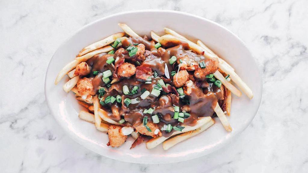 Poutine · French fries tossed in ranch seasoning, topped with cheese curds, beef gravy, green onions and diced bacon.