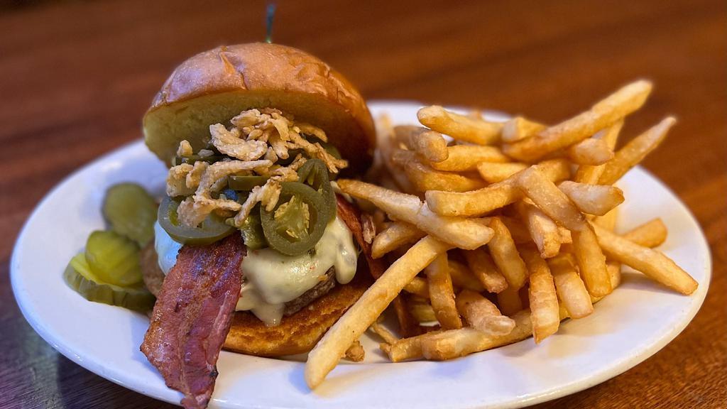 Jalapeno Juicy Lucy · 1/2 pound beef patty served on a large hamburger bun with jalapeno cream cheese, topped with pepper jack cheese, bacon, crispy onions and jalapenos.
