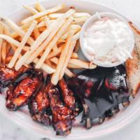 Ribs & Wings · Half rack of ribs served with half. Order of traditional or boneless wings tossed in your ch...