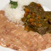 Frejoles Con Seco · Beef cooked in cilantro sauce with side beans, and rice