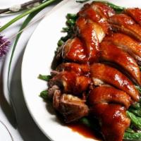 Roast Duck With Green Beans · Tender roasted duck breast served on top of fresh green beans and chef’s specialty brown sau...