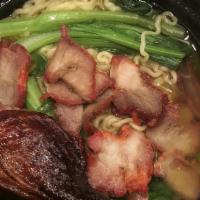 Famous Ramen · Flavorful roasted duck leg, roasted pork and choi sum (spinach-like vegetable) on ramen nood...