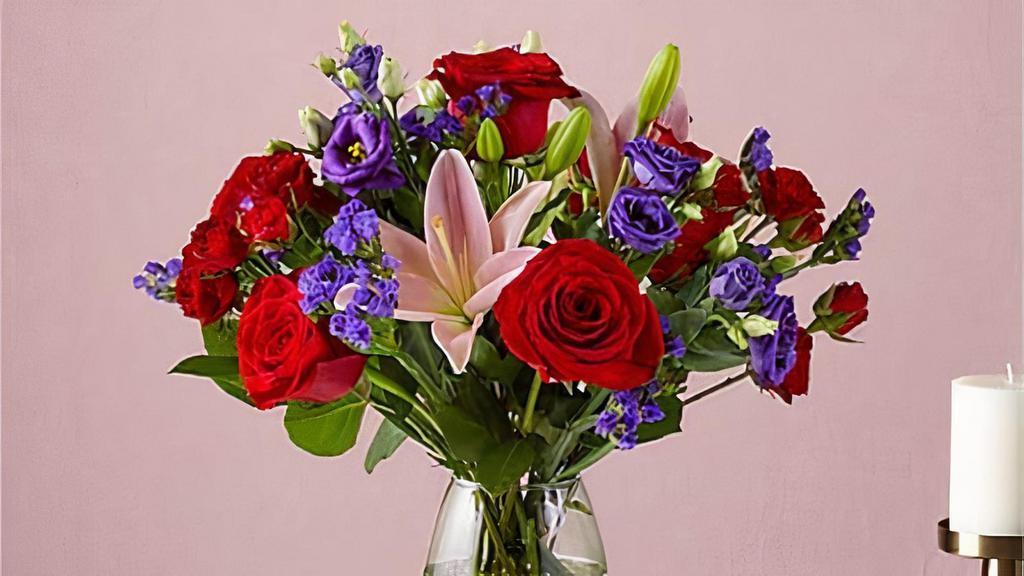 Truly Stunning Bouquet · This dreamy jewel toned bouquet combines bold color and eye catching texture to make a statement. Featuring a thoughtful array of both roses and lilies, this dazzling assortment is bound to impress your recipient. Vase included. Please Note: The bouquet pictured reflects our original design for this product. While we always try to follow the color palette, we may replace stems to deliver the freshest bouquet possible. Item # TSBS