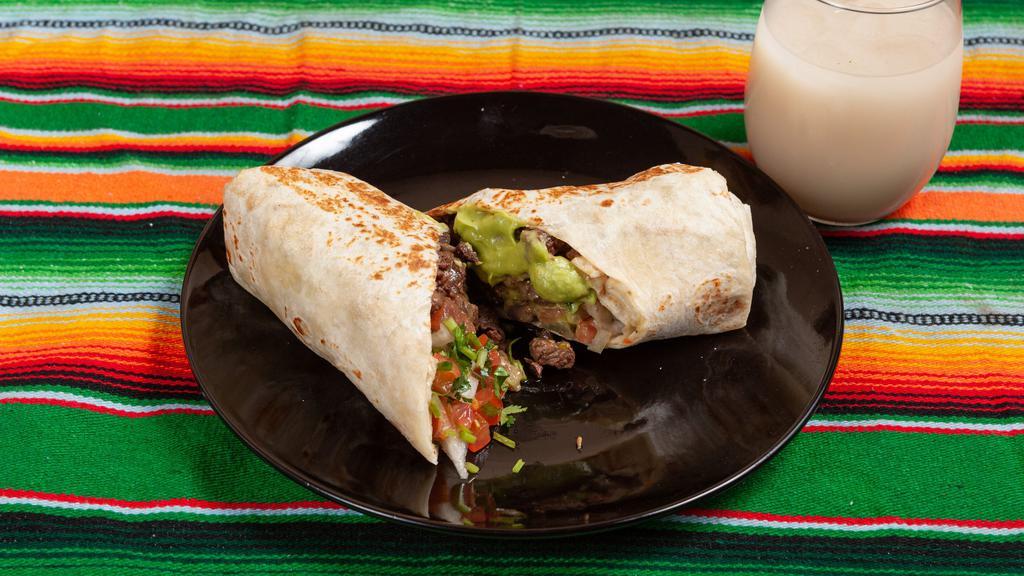 Carne Asada Burrito · Carne asada guacamole and pico de gallo,included rice and beans