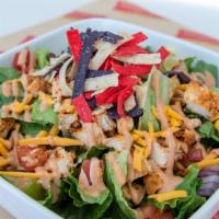 South West Salad With Cajun Chicken · Fresh cut romaine, black beans, corn, cheddar cheese, cilantro, red onion, tomato, and chipo...