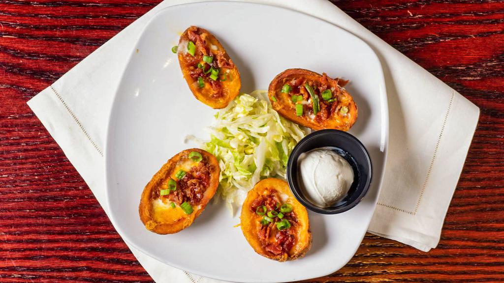 Potato Skins · Loaded with bacon, Cheddar cheese, scallions, served with sour cream.